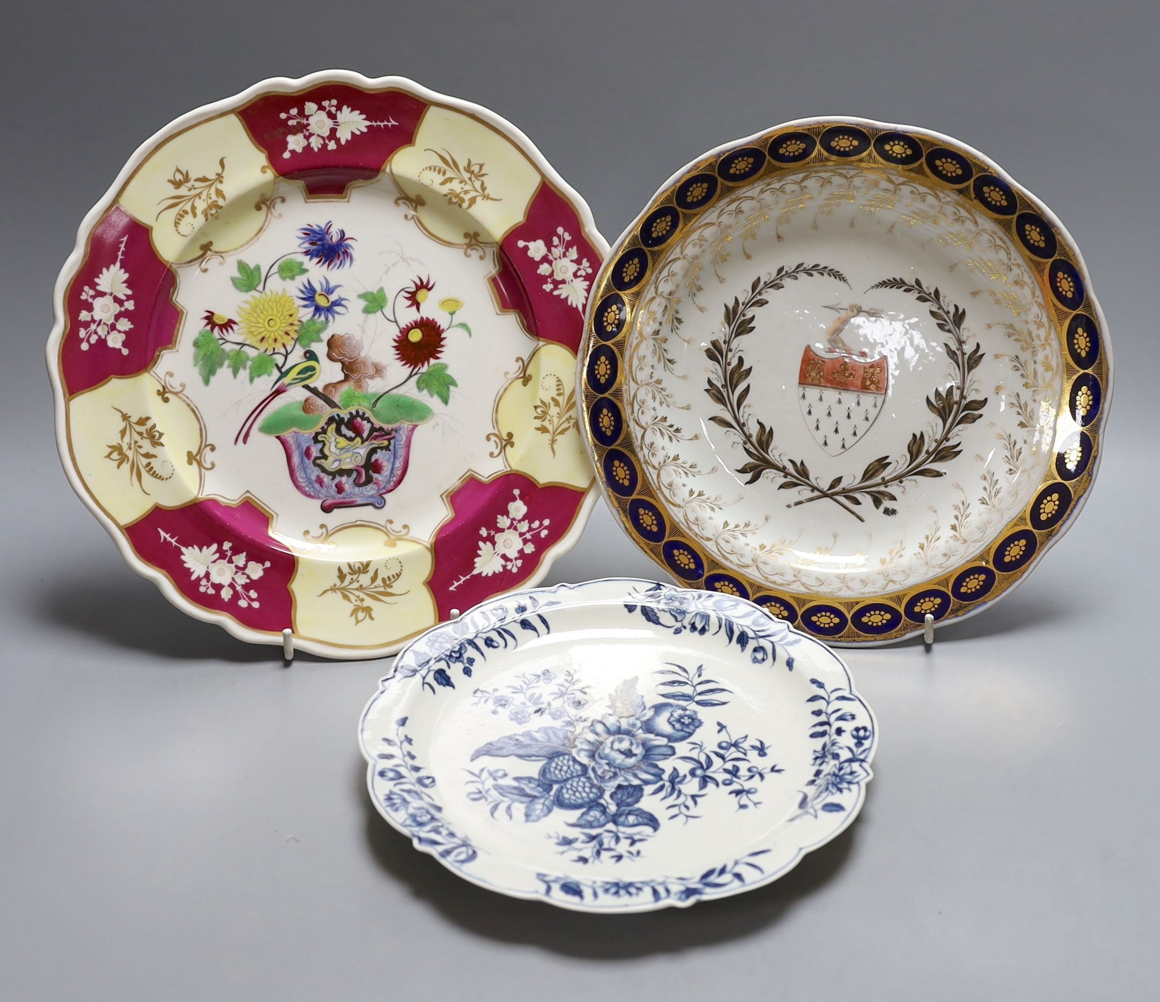 A Chamberlains Worcester armorial plate, a Worcester pinecone pattern plate, c.1775 and a Chamberlains Worcester chinoiserie plate (3) largest 27cm diameter